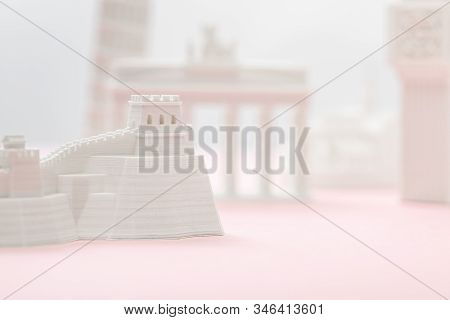 Selective Focus Of Small Great Wall Figurine Near Statuettes On Grey And Pink