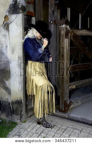 Cowgirl With Cowboy Hat And Fancy Buckskin Dress.
