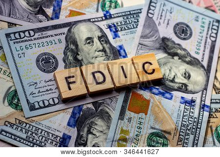 The Word Fdic On Dollar Usa Background. Usa Federal Deposit Insurance Corporation Concept.