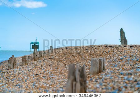 Remains Old Destroyed Pier On Stony Beach Along Rother River And Rye Nature Reserve.