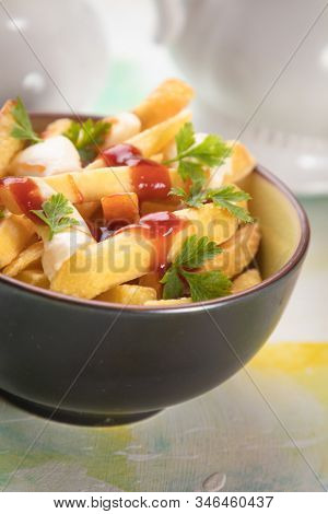 Canadian poutine, fried potato chips with cheese and gravy or sauce