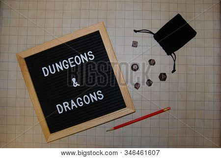 Dungeons And Dragons With Brown Metalic Die On Strategy Board