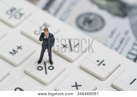 Miniature People Business Man Standing And Thinking On Calculator Percentage Button Using As Fed Con
