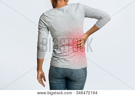 Kidney Stones. Afro Woman Holding Her Hand Behind Back, Pain In Kidney, Inflamed Zone Highlighted In