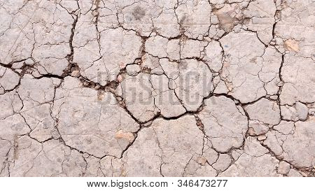 Broken Ground Or Close-up Damaged  Soil. Photo Of Land In The Desert. Cracked Soil Crust. Hard Shado