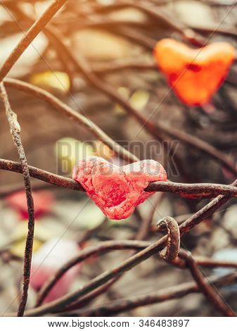 A Chunk Of A Red Heart Shaped Candle Adheres To An Old Rusted Steel Rod.  A Valentine's Day Backgrou