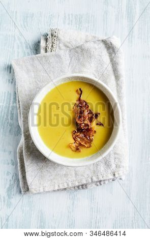 Cream of potato and leek soup with turmeric, topped with caramelized challots