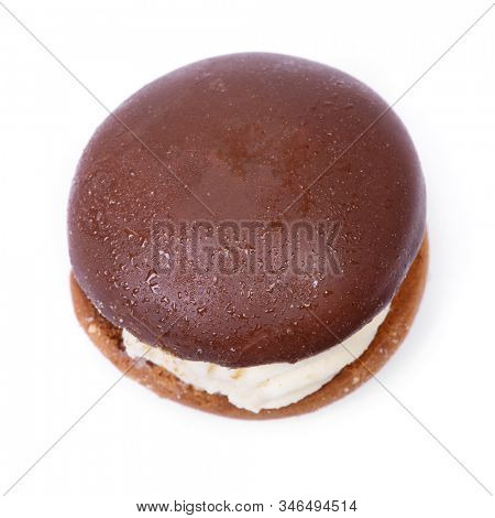 One sandwich cake with cream filling and chocolate glaze isolated on white background