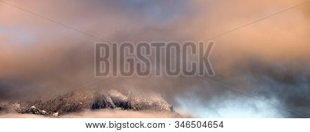 Fluffy Clouds In Evening Twillight Overcast Sky View. Mountain Tops Silhouettes In Clouds. Climate, 