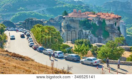 Meteora, Kalamaka, Greece - September 19, 2019:  Many tourist's cars parked near The Monastery of Varlaam in Meteora 