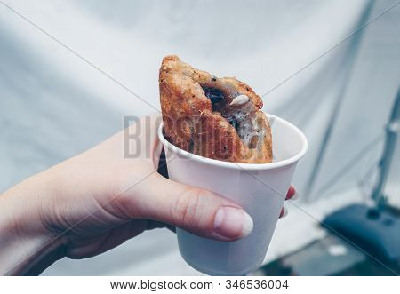 Woman Hand Holding Freshly Made Korean Sweet Pancake -hodduk In White Paper Cup