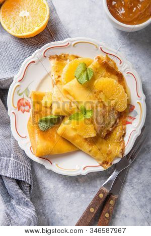 Orange Crepes Suzette. Traditional French Crepe Suzette With Orange Sauce . Top View, Flat Lay