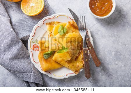 Crepe Suzette. Traditional French Crepe Suzette With Orange Sauce . Top View, Flat Lay