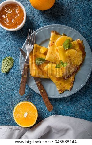 Crepe Suzette. Traditional French Crepe Suzette With Orange Sauce . Top View, Flat Lay