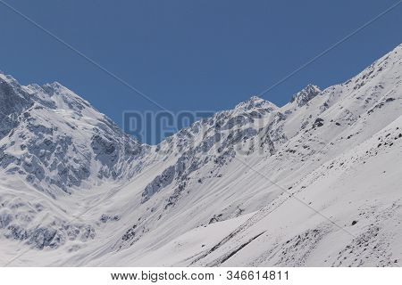 Natural Monument El Morado, Central Andes Of Chile. A Snowy Mountain Slopes