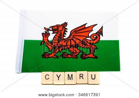The National Flag Of Wales On A White Background With A Sign Reading Cymru