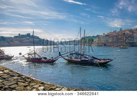 Portugal,  Porto, A Group Of Wooden Boats With Wine Port Barrels Close Up On Douro, Porto By River, 