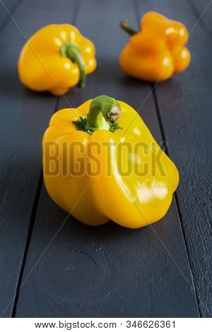Ugly Yellow Bell Peppers Deformed Shaped On The Wooden Gray Background. Trendy Misshapen Food. Stran