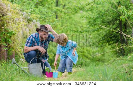 Planting Flowers. Dad Teaching Little Son Care Plants. Little Helper In Garden. Make Planet Greener.