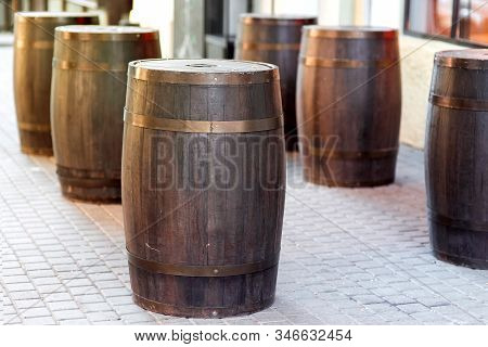 Brown Wooden Barrel On The City Street On Stone Tile, Row Of Cask Decorations Close Up Nobody.