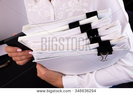 Business Woman Office Workers Holding Are Arranging Documents Of Unfinished Documents On Office Desk