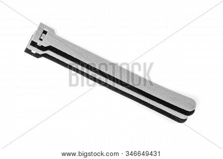 Black And Grey Velcro Strips Isolated On White Background.devices For Storing Cables, Chargers Gadge