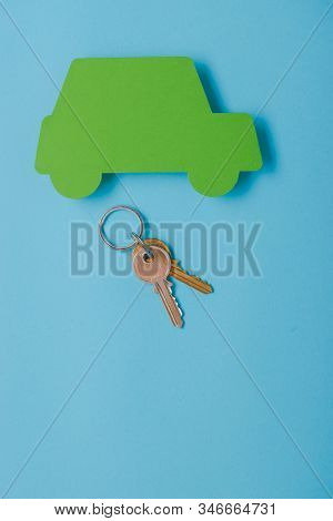 Paper Green Cars Figure With Keys. Top View On Blue Background