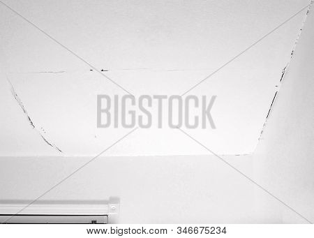 A Crack In A White Ceiling Of A Generic, Unidentified Old House, And A Crack In The Corners Where Th