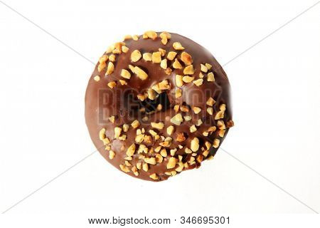 chocolate Donut with peanuts. isolated on white. room for text. clipping path. People world wide enjoy donuts. Enjoy a Donut today. 
