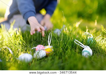 Little Boy Hunting For Egg In Spring Garden On Easter Day. Traditional Easter Festival Outdoors. Foc