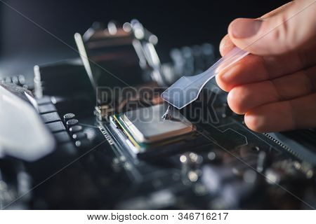 Technical Support Worker Greases With Thermal Grease Paste Computer Processor. Thermal Compound On O