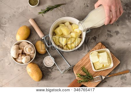 Woman Preparing Tasty Mashed Potato At Table