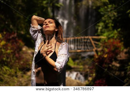 Woman near Labuhan Kebo Waterfall located in Munduk, Bali