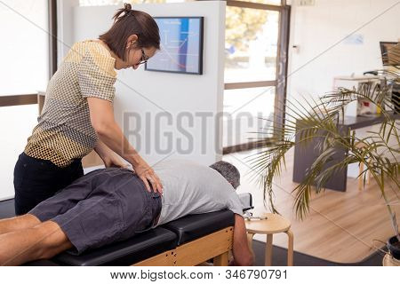 Man Having Chiropractic Back Adjustment. Physioterapy, Osteopathy, Alternative Medicine Pain Relief 