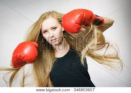 Bloned Long Hair Girl Boxer In Big Fun Red Gloves Playing Sports Boxing. Female Fight For Equal Righ