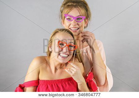 Happy Two Women Holding Paper Decoration Photo Booth Mask Glasses On Stick, Having Fun. Wedding, Bir