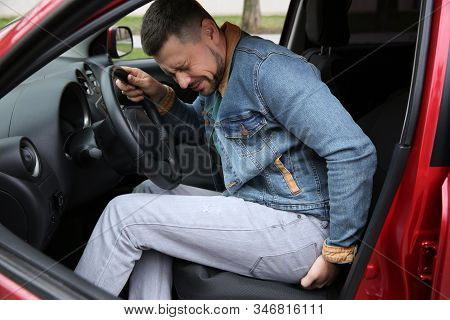 Man Suffering From Hemorrhoid Pain In Car