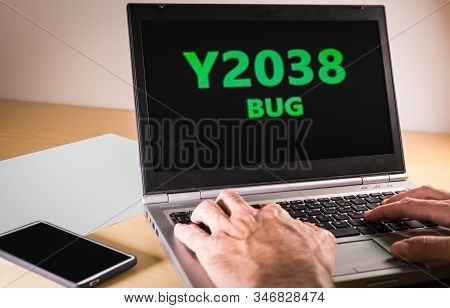 Man Hands Typing On A Laptop In Text Code. Y2038 Problem Concept