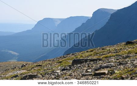 Layers Of Mountains Behind Rocky Field In Montana Wilderness