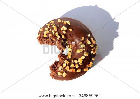 chocolate Donut with peanuts. isolated on white. room for text. clipping path. People world wide enjoy donuts. Enjoy a Donut today. 