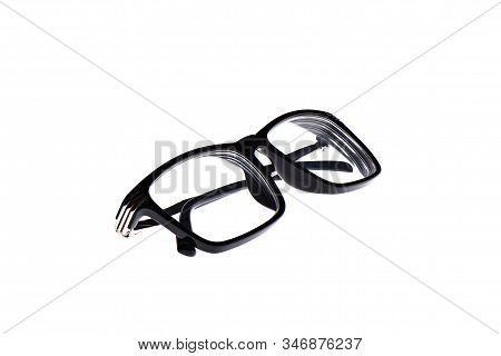 Glasses In A Black Plastic Frame Isolated On A White Background. Glasses With Plastic Earhooks. Copy