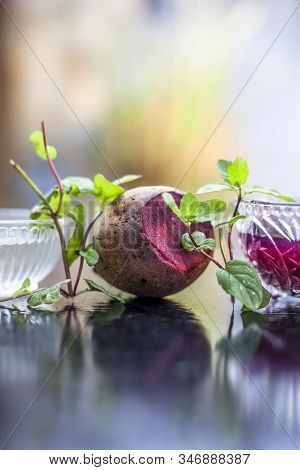 Home Remedy For Dandruff On Wooden Surface I.e., Beetroot Stock Well Mixed With Water In A Glass Bow