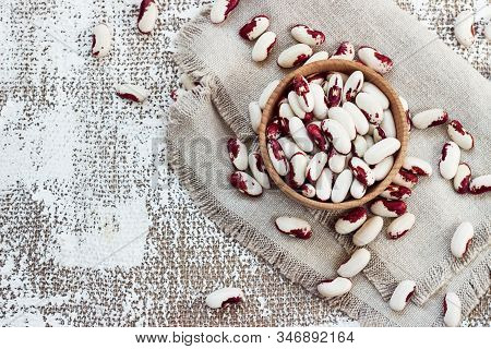 White-pink Beans In A Wooden Cup On A Light Background