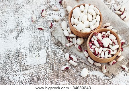 White-pink Beans In A Wooden Cup On A Light Background