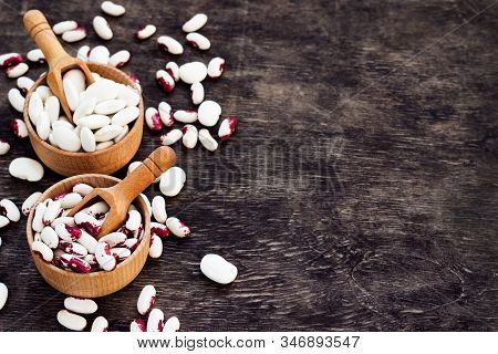 Colored Beans In Wooden Cups On A Dark Wooden Background