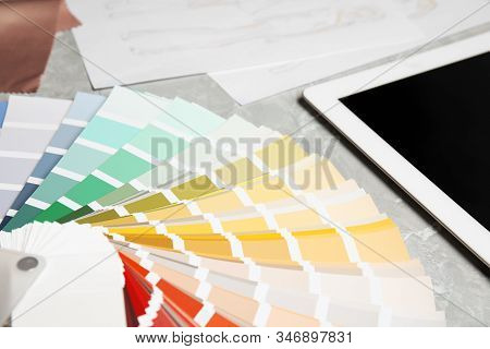 Palette Samples And Tablet On Grey Marble Table, Closeup. Designer's Workplace