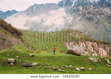 Stephantsminda, Georgia. Woman Tourist Are Photographed Spring Mountain Landscape.