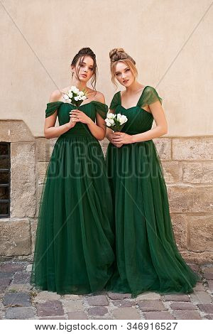 Two Beautiful Bridesmaids Girls Blonde And Brunette Ladies Wearing Elegant Full Length Off-the-shoul