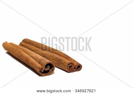 Flavored Cinnamon Sticks Isolated On A White Background. Two Sticks Of Dried Cinnamon Isolated On A 