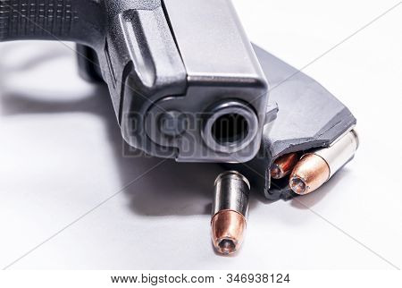 A Black 9mm Semi Automatic Pistol With A Loaded Pistol Magazine With A Single 9mm Hollow Point Bulle